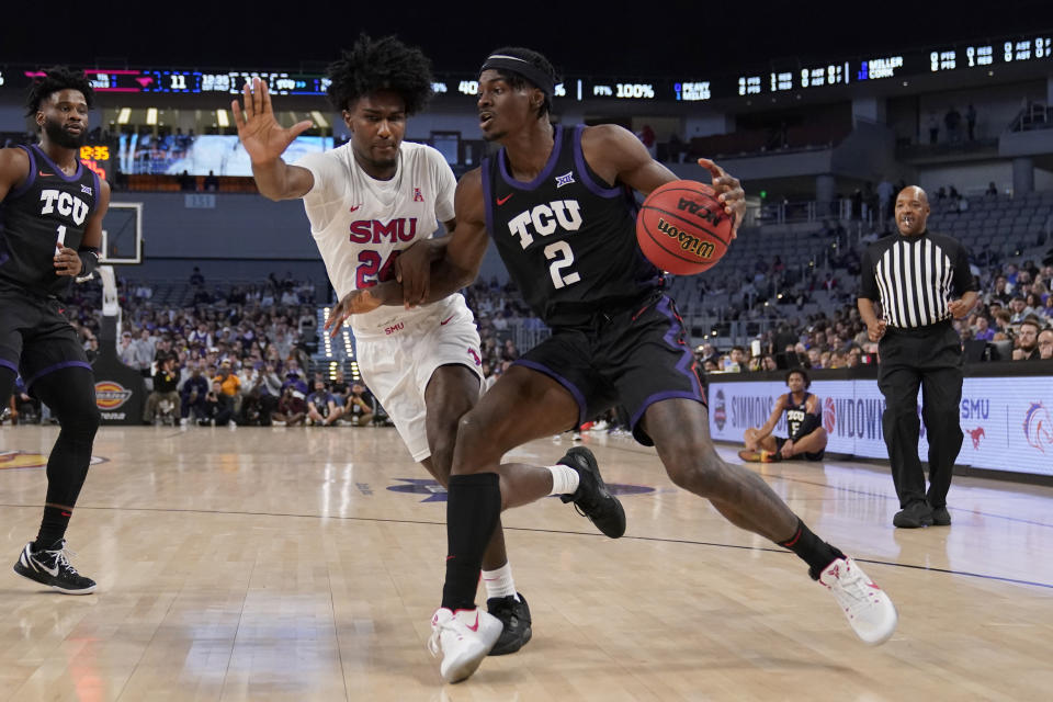 TCU forward Emanuel Miller (2) attempts to move to the basket as SMU guard Emory Lanier, center left, defends in the first half of an NCAA college basketball game, Saturday, Dec. 10, 2022, in Fort Worth, Texas. (AP Photo/Tony Gutierrez)