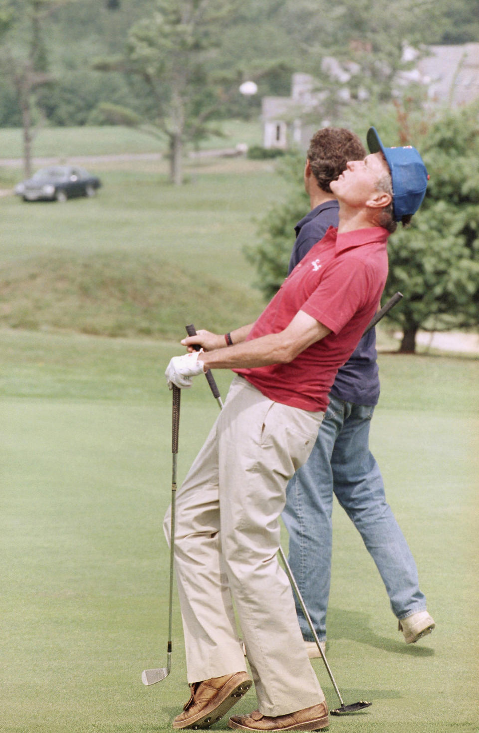 George H.W. Bush reacts to a putt missed by Jeb while on vacation in Kennebunkport, August 1989.