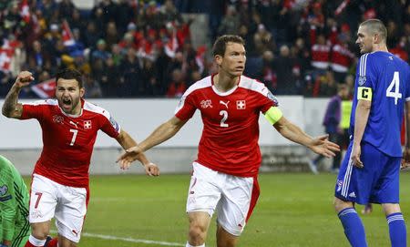 Football Soccer - Switzerland v Faroe Islands - World Cup 2018 Qualifier - Swissporarena, Luzern, Switzerland - 13/11/16 . Switzerland's Stephan Lichtsteiner and Renato Steffen react REUTERS/Ruben Sprich