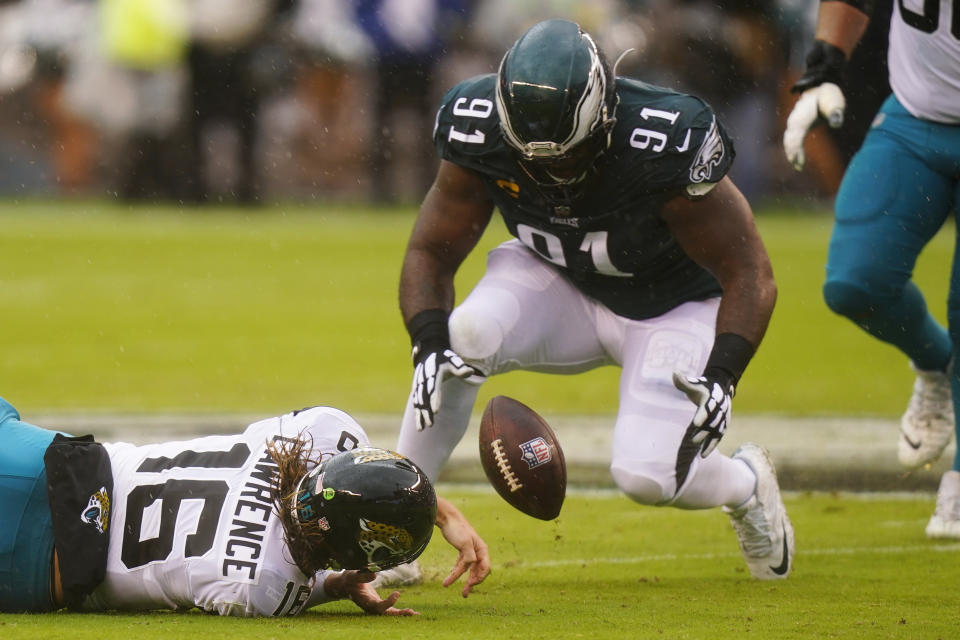 Jacksonville Jaguars' Trevor Lawrence fumbles the ball and Philadelphia Eagles' Fletcher Cox recovers it during the first half of an NFL football game Sunday, Oct. 2, 2022, in Philadelphia. (AP Photo/Chris Szagola)