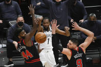 Brooklyn Nets forward Kevin Durant (7) passes the ball away from Chicago Bulls forward Patrick Williams (44) and center Nikola Vucevic (9) during the second half of an NBA basketball game Tuesday, May 11, 2021, in Chicago. (AP Photo/Matt Marton)