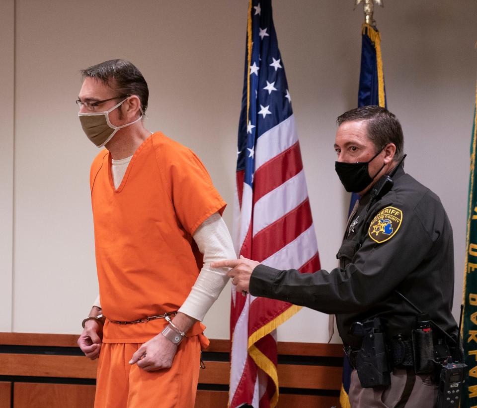 James Crumbley, father of Ethan Crumbley, who is accused of the deadly school shooting at Oxford High School in late November, is escorted into 52/3 District Court in Rochester Hills Thursday, Feb. 24, 2022.