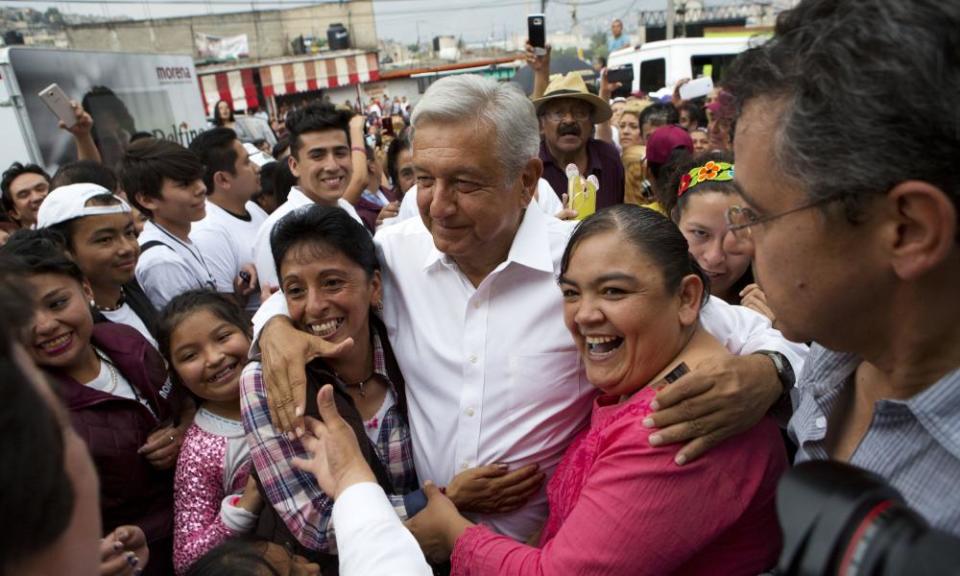 Andrés Manuel López Obrador is surrounded by supporters as he arrives at a campaign event for Delfina Gomez.