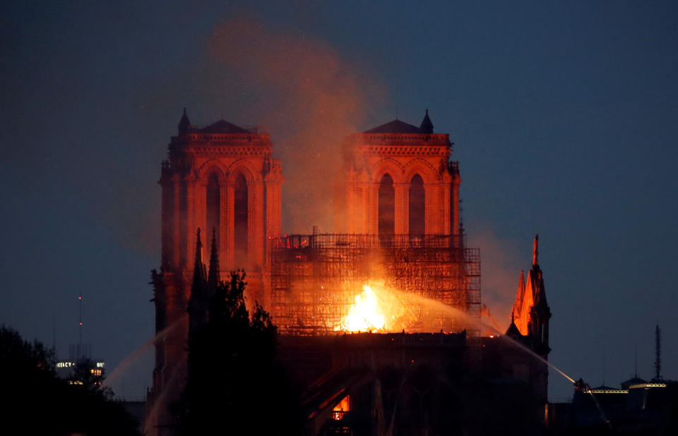 Firefighters douse flames of the burning Notre Dame Cathedral in Paris. Source: Reuters/Charles Platiau