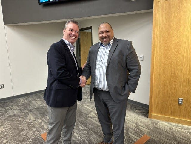 Incoming Ames CSD Superintendent Scott Grimes shakes hands with current Superintendent Julious Lawson.