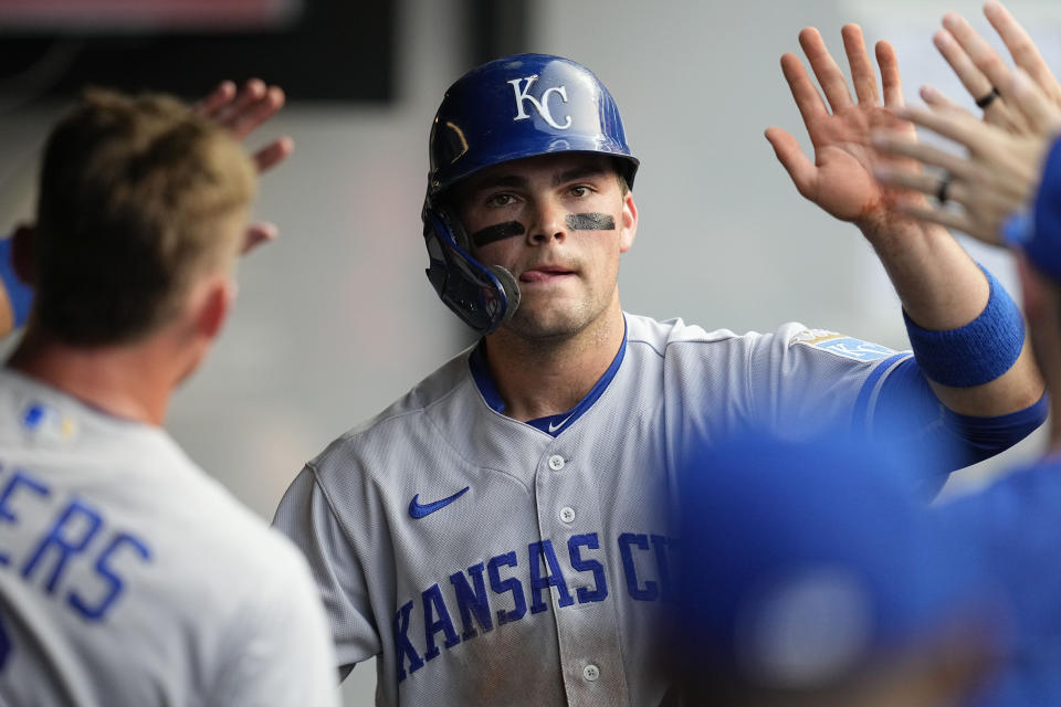 Kansas City Royals' Michael Massey, center, is congratulated in the dugout after scoring against the Cleveland Guardians during the fifth inning of a baseball game Tuesday, July 25, 2023, in Cleveland. (AP Photo/Sue Ogrocki)