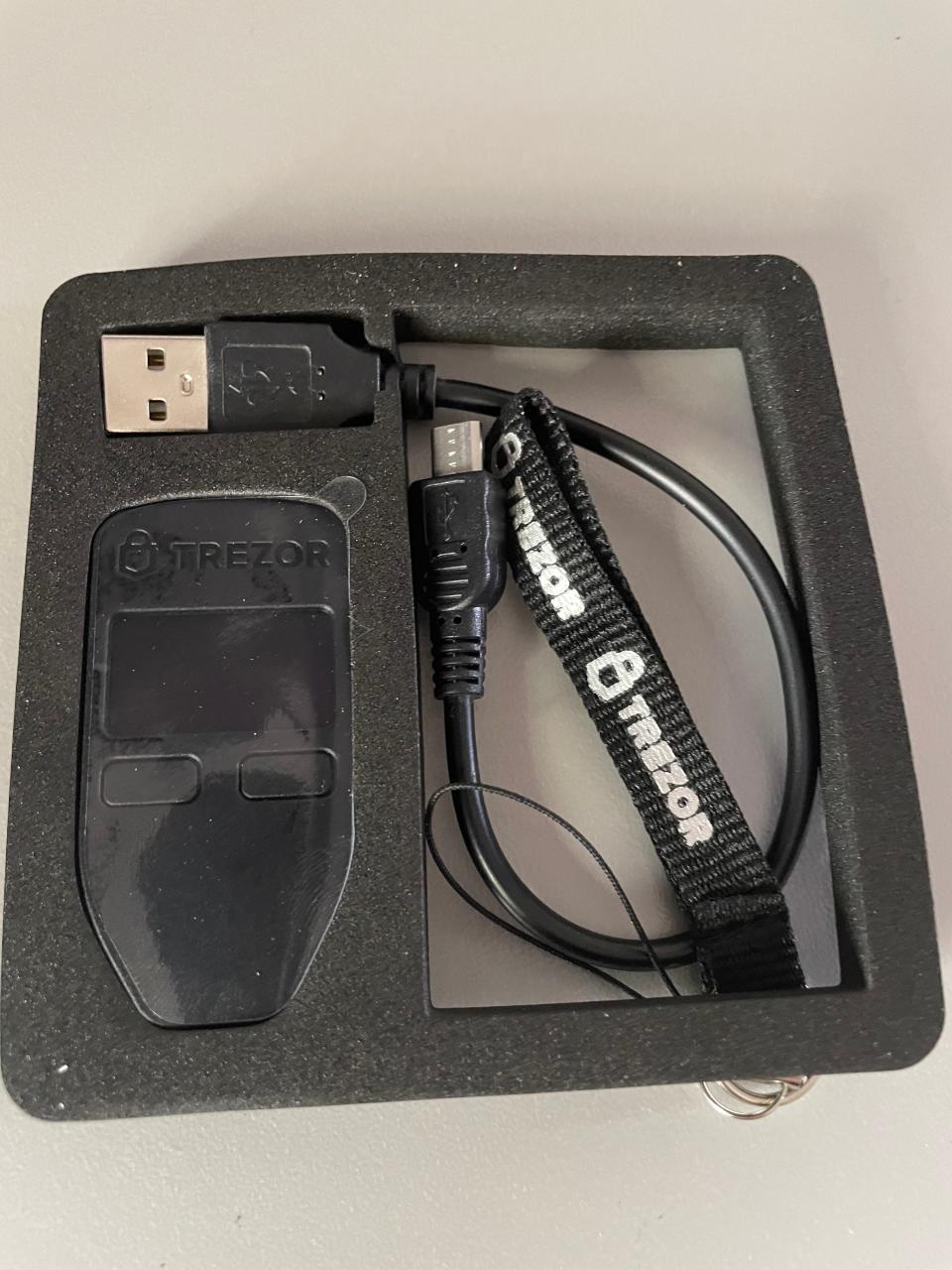 Trezor packaging contents including hard wallet, USB and lanyard