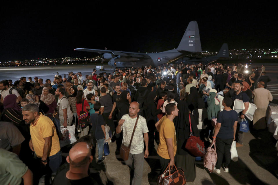 FILE - Jordanians evacuated from Sudan arrive at a military airport in Amman, Jordan, on April 24, 2023. In the country's capital, Sudan's army and the paramilitary group known as the Rapid Support Forces have battled in the streets with automatic rifles, artillery and airstrikes. An AP journalist, waiting for a chance to leave the country, sheltered with a diverse group of more than a dozen people who hunkered down in a small hotel in central Khartoum. (AP Photo/Raad Adayleh, File)