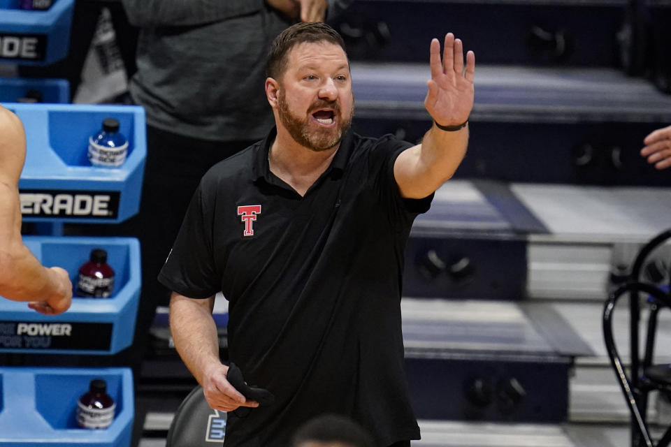 Texas Tech head coach Chris Beard signals to his team as they played against Arkansas in the first half of a second-round game in the NCAA men's college basketball tournament at Hinkle Fieldhouse in Indianapolis, Sunday, March 21, 2021. (AP Photo/Michael Conroy)
