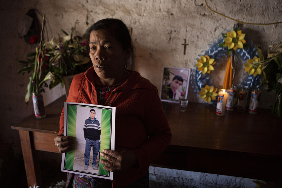 Elena Marroquin poses for a portrait holding a photo of her grandson Rivaldo Danilo Jimenez, in her home in Comitancillo, Guatemala, Wednesday, Jan. 27, 2021. She believes that her grandson was one of 19 bodies, shot and burned, found in late January, inside a pickup truck near the Mexico-Texas border. (AP Photo/Oliver de Ros)