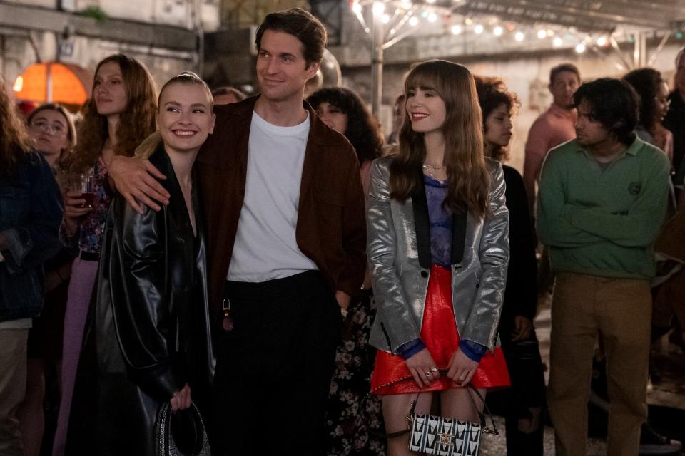 Emily in Paris. (L to R) Camille Razat as Camille, Lucas Bravo as Gabriel, Lily Collins as Emily in episode 302 of Emily in Paris.