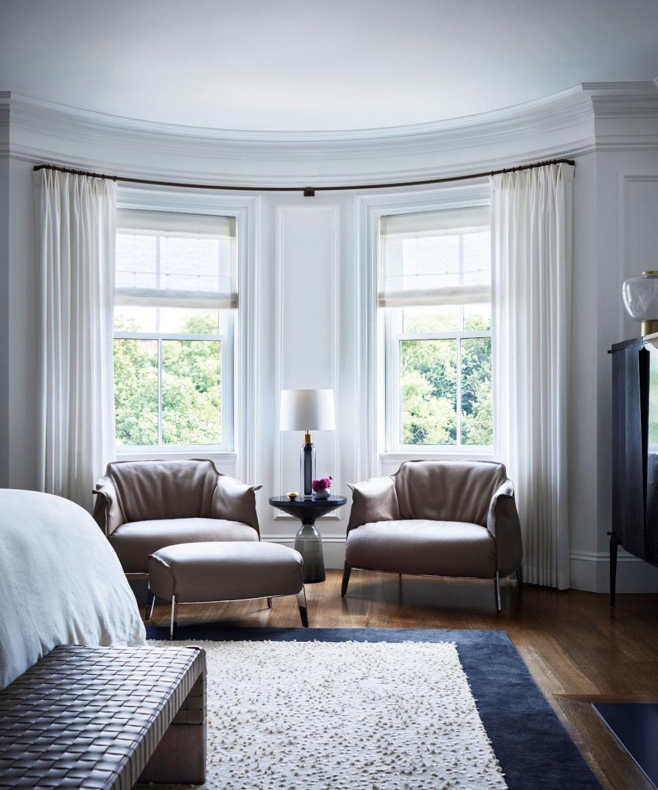 bedroom with chairs in window