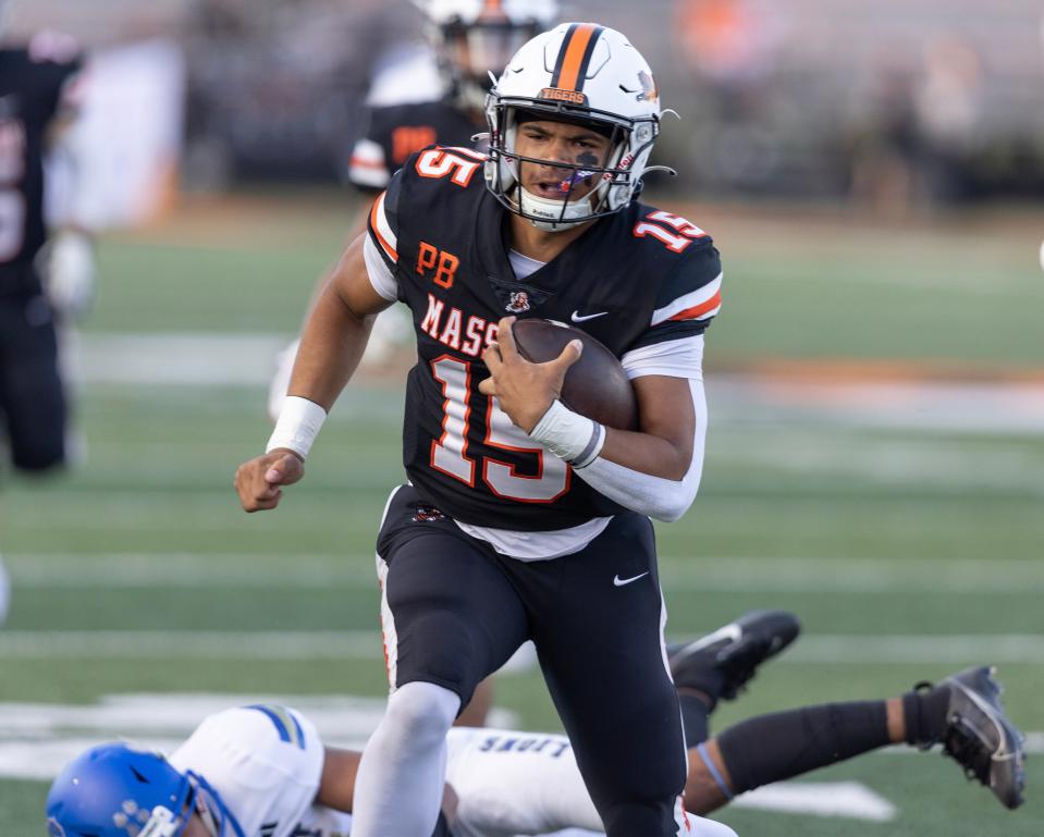 Massillon quarterback DaOne Owens eludes an Elkhart, Indiana defender for a first-quarter touchdown, Friday, Sept. 8, 2023.