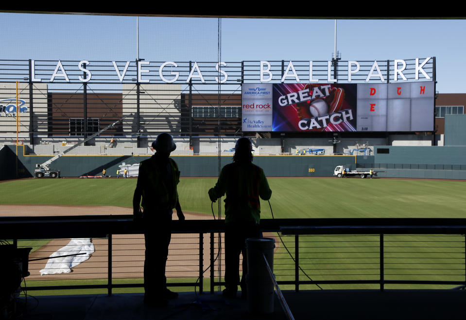 FILE - Workers continue construction on a new baseball park in Las Vegas on March 28, 2019. The Oakland Athletics's lease at Oakland Coliseum runs through 2024, and there is a chance the team would play the 2025 and 2026 seasons at Las Vegas Ballpark, home to their Triple-A affiliate, the Aviators. (AP Photo/John Locher, File)