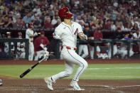 Arizona Diamondbacks' Alek Thomas watches the flight of his three-run home run against the Colorado Rockies during the third inning of a baseball game Friday, March 29, 2024, in Phoenix. (AP Photo/Ross D. Franklin)