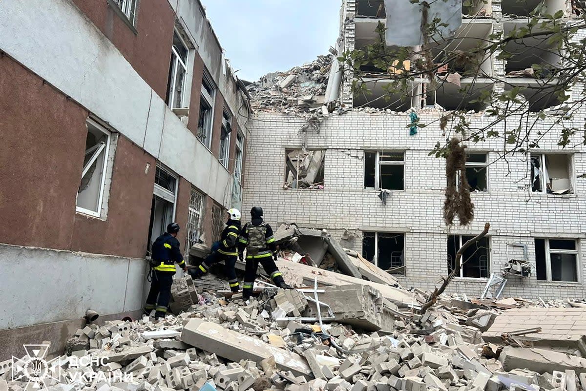 Ukrainian emergency service rescuers work at the site of a Russian missile strike in Chernihiv (AP)