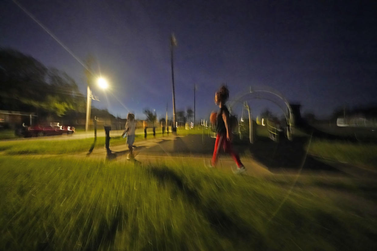 Jada Riley leaves a basketball court as she walks to her car with her 6-year-old son Jayden Harris, Thursday, July 28, 2022, near her former apartment in New Orleans. Eviction filings nationwide have steadily risen in recent months and are approaching or exceeding pre-pandemic levels in many cities and states. That's in stark contrast to the pandemic, when state and federal moratoriums on evictions, combined with $46.5 billion in federal Emergency Rental Assistance, kept millions of families housed. (AP Photo/Gerald Herbert)