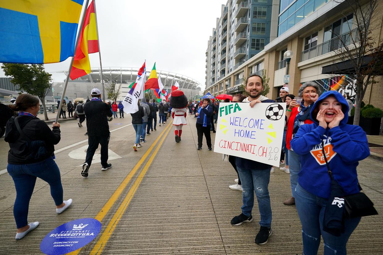 FIFA World Cup 2026 supporters cheer as a parade of flags is walked down Freedom Way toward Paul Brown Stadium as the 2026 Cincy Local Organizing Committee hosted a street festival ahead of a visit by a FIFA and US Soccer Delegation, Friday, Oct. 22, 2021, in Downtown Cincinnati. The delegation visited Paul Brown Stadium, soccer training facilities and Fan Fest locations.