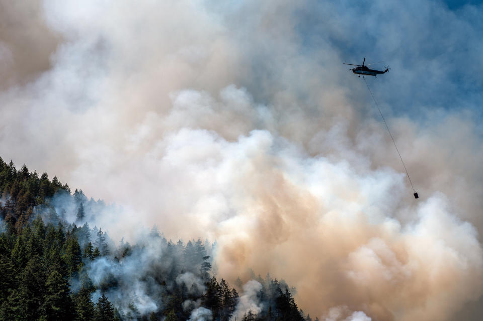 A helicopter waterbomber flies above the Cameron Bluffs wildfire near Port Alberni, British Columbia, Canada, on Tuesday, June 6, 2023. Canada is on track to see its worst-ever wildfire season in recorded history if the rate of land burned continues at the same pace. Photographer: James MacDonald/Bloomberg