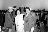 FILE - Jack Burke, Jr., wearing his championship jacket, cheers with his wife, Eilene, after winning the Masters Golf Tournament at the Augusta National Golf Club in Augusta, Ga., April 8, 1956. Jack Burke Jr., the oldest living Masters champion who staged the greatest comeback ever at Augusta National for one of his two majors, died Friday morning, Jan. 19, 2024, in Houston. He was 100. (AP Photo/File)