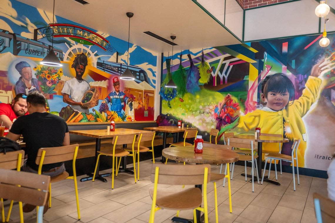 Murals called “The Peoples Market”, left, and “Our Imagination Bringer” by Isaac Tapia and Rodrigo “Rico” Alvarez, cover the walls in a dining area at the new terminal at Kansas City International Airport.