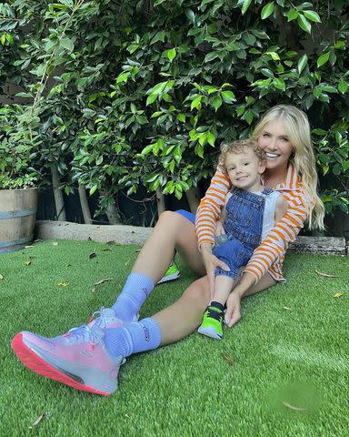 Amanda Kloots/Instagram Amanda Kloots and her son Elvis pose outside on the grass