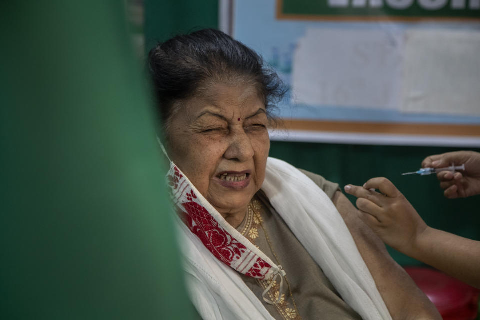 An elderly woman receives the COVID-19 vaccine at a private hospital in Gauhati, India, Thursday, March 4, 2021. The COVID-19 vaccination drive for senior citizens and those above 45 years of age with comorbidities began in government and designated private hospitals in Gujarat on Monday along with the rest of the country. (AP Photo/Anupam Nath)