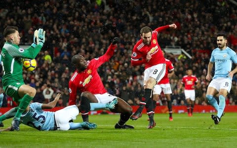 Juan Mata has an attempt at goal saved by Manchester City goalkeeper Ederson - Credit: Martin Rickett/PA Wire