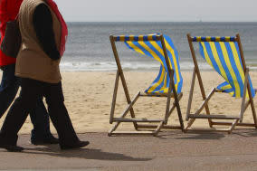 File photo dated 03/05/10 of two women walking along the beach in Bournemouth as almost one in four people scheduled to retire this year say they are not ready to stop work, according to a report. PRESS ASSOCIATION Photo. Issue date: Friday February 7, 2014. A survey of more than 1,000 people nearing retirement found that one in seven had already delayed their plans. A wider poll of around 7,000 adults found that just over half would consider working beyond the state pension age because of financial considerations. Prudential said its study also revealed that many people wanted to carry on working to keep mentally and physically fit. See PA story INDUSTRY Retire. Photo credit should read: Chris Ison/PA Wire