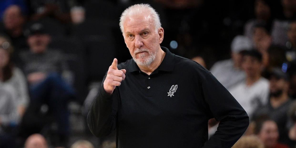 Gregg Popovich stands on the sideline and points during a game in 2022.