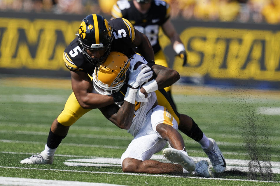 Kent State wide receiver Dante Cephas (14) is tackled by Iowa linebacker Jestin Jacobs (5) after catching a pass during the first half of an NCAA college football game, Saturday, Sept. 18, 2021, in Iowa City, Iowa. (AP Photo/Charlie Neibergall)