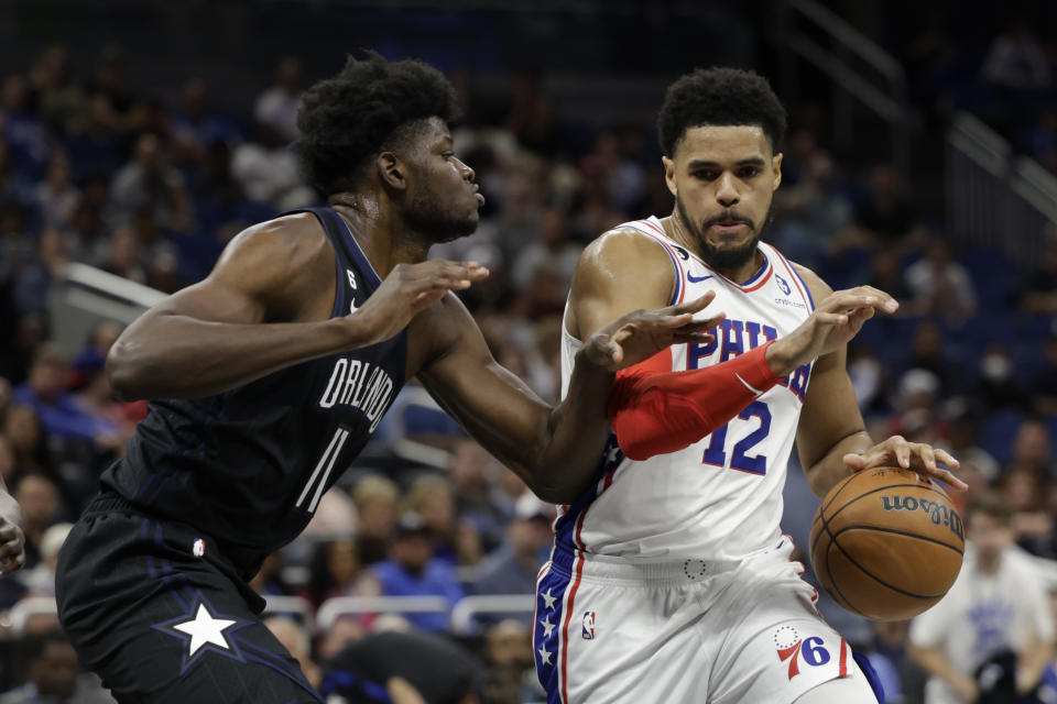 Philadelphia 76ers forward Tobias Harris (12) is defended by Orlando Magic center Mo Bamba (11) during the first half of an NBA basketball game, Friday, Nov. 25, 2022, in Orlando, Fla. (AP Photo/Kevin Kolczynski)