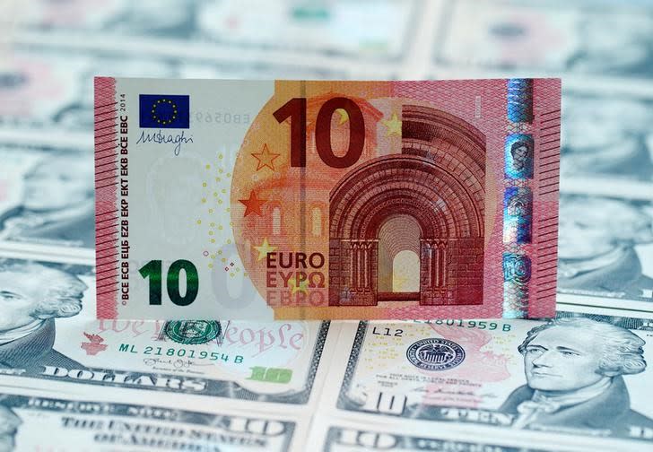 U.S. dollar and euro banknotes are seen in this picture illustration, March 16, 2015. REUTERS/Heinz-Peter Bader/Illustration/File Photo