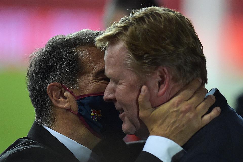 Barcelona's Dutch coach Ronald Koeman (R) celebrates with club president Joan Laporta at the end of the Spanish Copa del Rey (King's Cup) final football match between Athletic Club Bilbao and FC Barcelona at La Cartuja stadium in Seville on April 17, 2021. (Photo by CRISTINA QUICLER / AFP) (Photo by CRISTINA QUICLER/AFP via Getty Images)