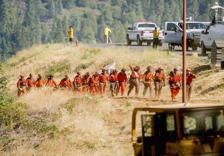 Inmate firefighters return to their truck after battling the King Fire near Fresh Pond, California September 17, 2014. REUTERS/Noah Berger