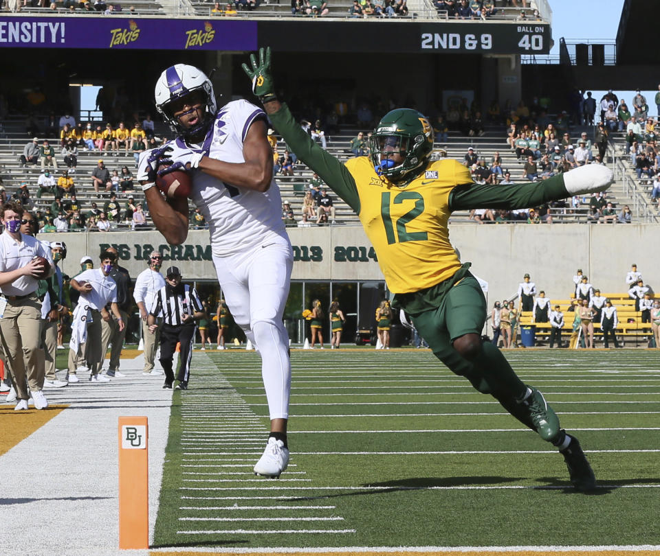 FILE - In this Oct. 31, 2020, file photo, TCU wide receiver Quentin Johnston, left, pulls in a pass close to the end zone over Baylor cornerback Kalon Barnes, right, in the first half of an NCAA college football game, in Waco, Texas. The Big 12 will have nothing like the Red River rivalry on the second Saturday in October once Texas and Oklahoma make their move to the Southeastern Conference. There will even be the renewal of some old but not as long standing feuds, and maybe some new ones when BYU, Central Florida, Cincinnati and Houston begin Big 12 play within the next two to three seasons. (Rod Aydelott/Waco Tribune-Herald via AP, File)