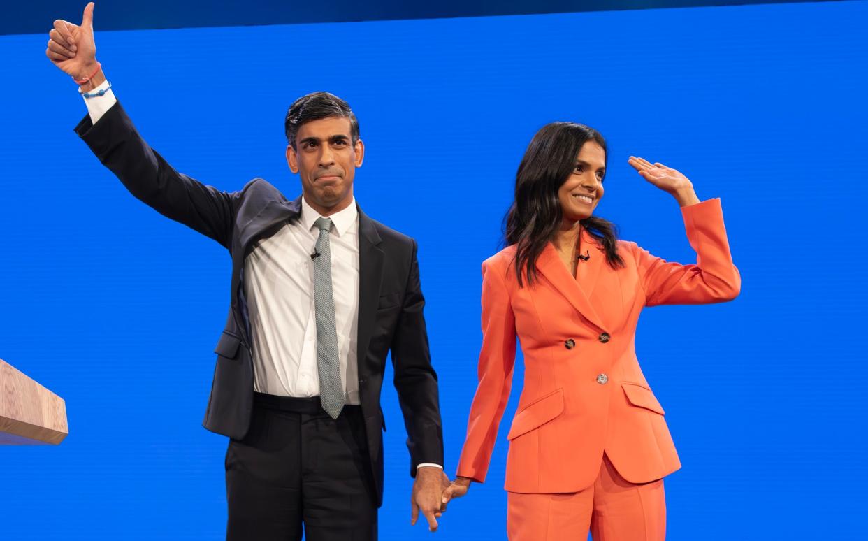 The Prime Minister acknowledges applause for his speech with his wife, Akshata Murty