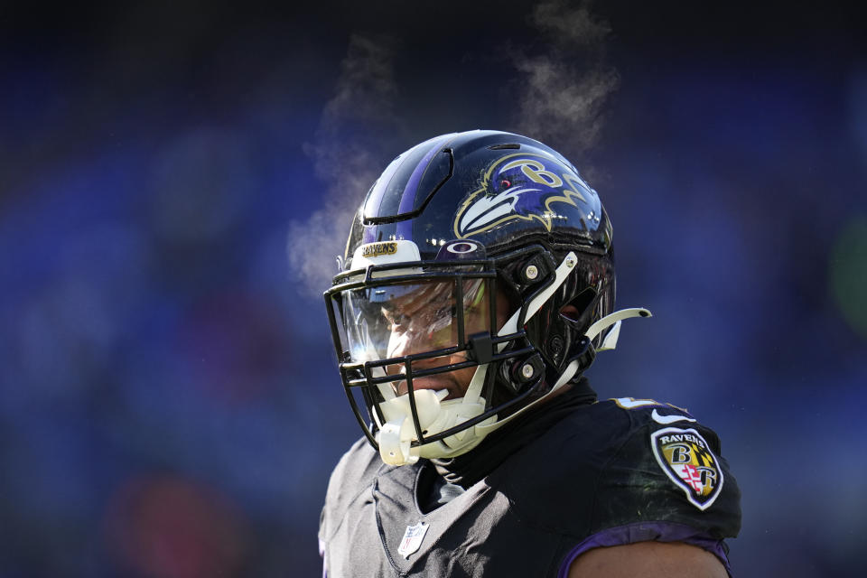 Vapor comes from the breath of Baltimore Ravens running back J.K. Dobbins (27) after a carry during the first half of an NFL football game against the Atlanta Falcons, Saturday, Dec. 24, 2022, in Baltimore. (AP Photo/Julio Cortez)