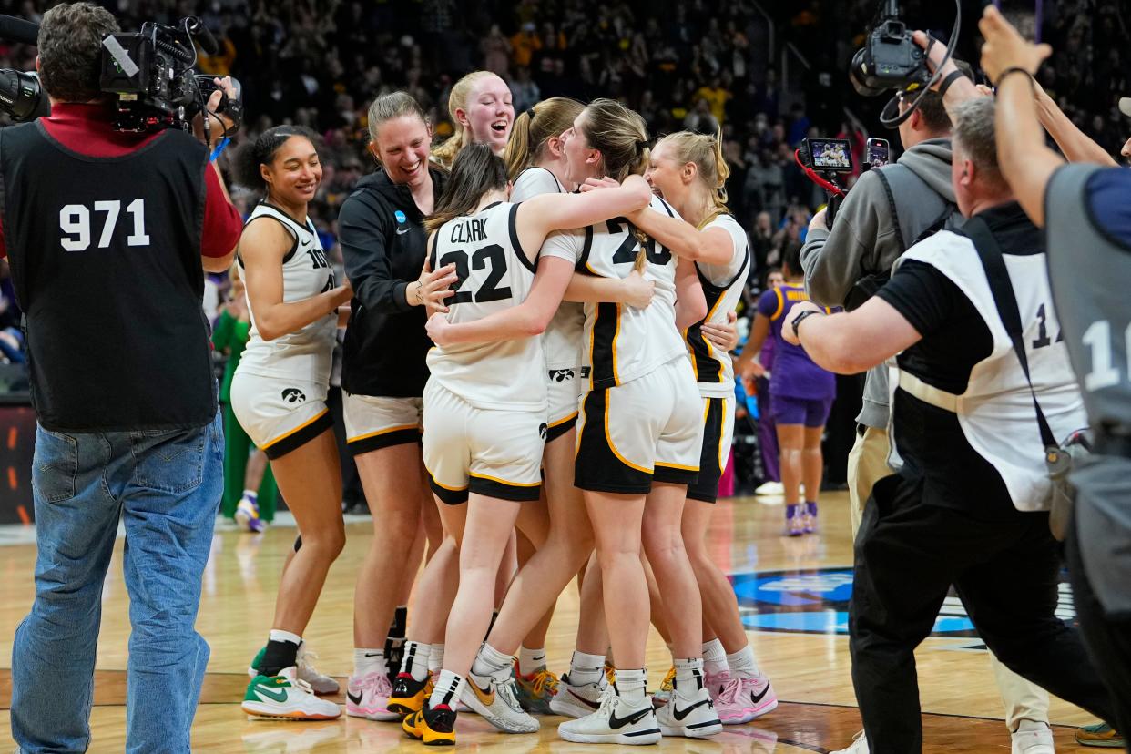 Iowa guard Caitlin Clark (22) celebrates with teammates after the Hawkeyes defeated the LSU Tigers in the Elite Eight of the Albany Regional.