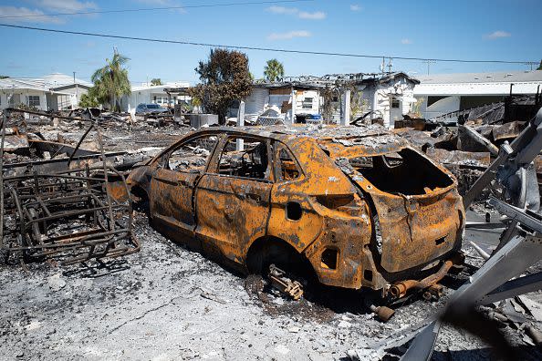 A burned vehicle from an electrical fire following Hurricane Ian in Venice, Florida, US, on Friday, Sept. 30, 2022. Two million electricity customers in Florida remained without power Friday morning, according to the tracking site poweroutage.us. Photographer: Tristan Wheelock/Bloomberg via Getty Images