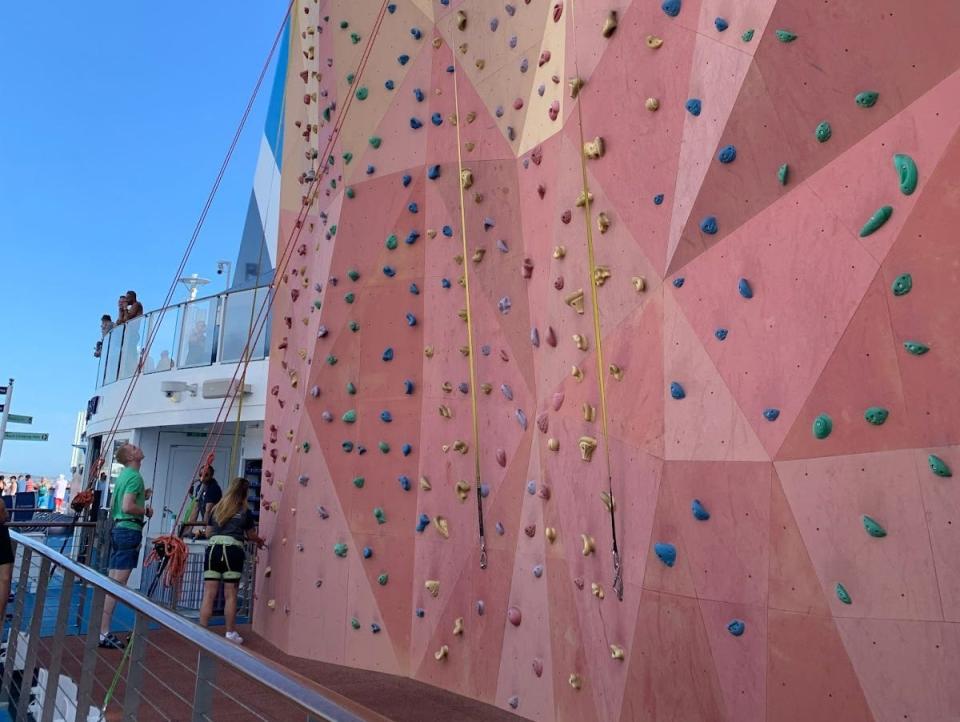 a pink rock climbing wall on the ship