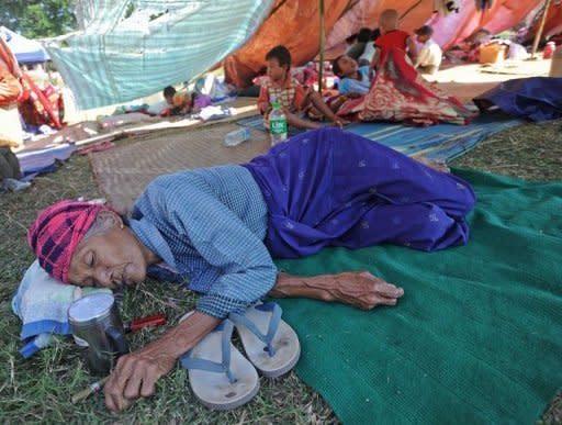 A victim of the recent earthquake in Mayanmar rests at a relief camp in Thabeik Kyin township, Mandalay. The quake left 26 people dead, 12 others missing and about 230 injured, the Red Cross says