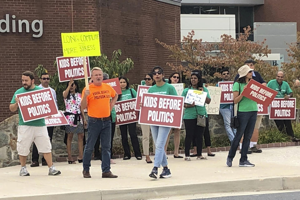 In this Sept. 26, 2019, photo, protesters stand outside Howard County government building in Ellicott City, Md. The group is opposed to a school redistricting plan that will force some students to be relocated to other schools. (AP Photo/Regina Garcia Cano)