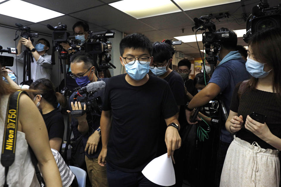 Pro-democracy activists who were elected from unofficial pro-democracy primaries, including Joshua Wong, center, attend a press conference in Hong Kong, Wednesday, July 15, 2020. Young activists and localist candidates dominated Hong Kong's unofficial pro-democracy primaries over the weekend, with hundreds of thousands of people voting despite warnings the election could violate the territory's new security law imposed by Beijing. (AP Photo/Kin Cheung)