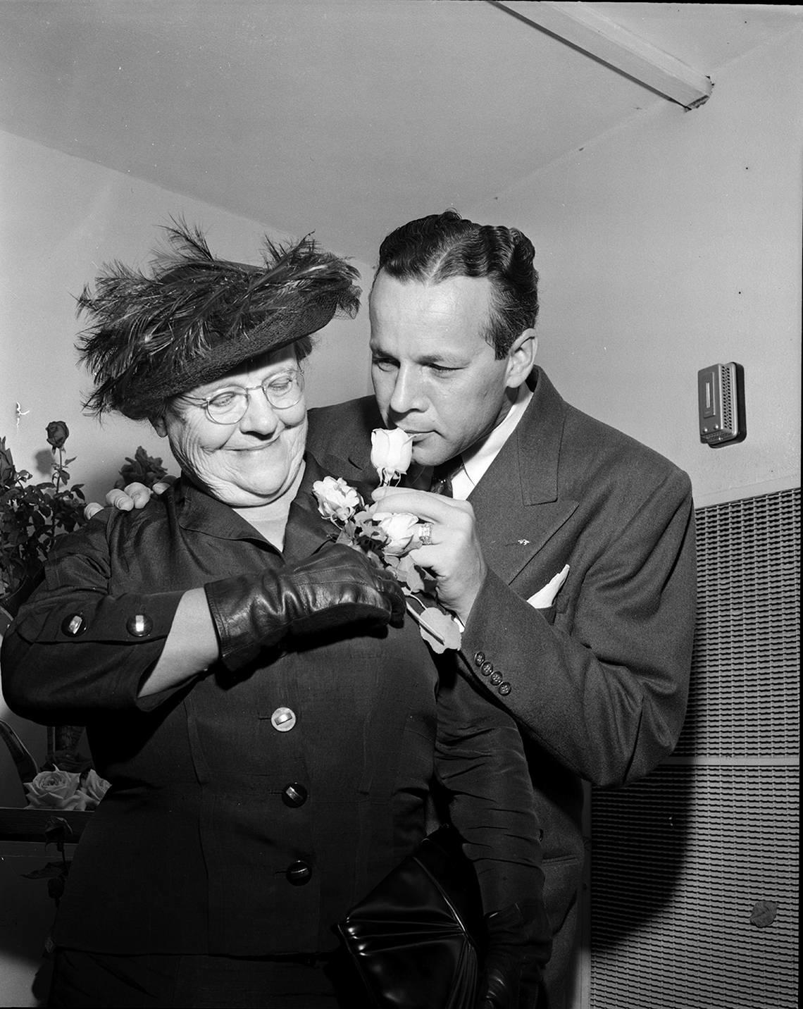 Oct. 20, 1950: C.J. Lauden of Tyler, president of the Texas Rose Festival, admires a rose worn by Mrs. Mary Daggett Lake at the second annual Rose Show at Leonard’s Department Store. The show attracted about 25,000 visitors.