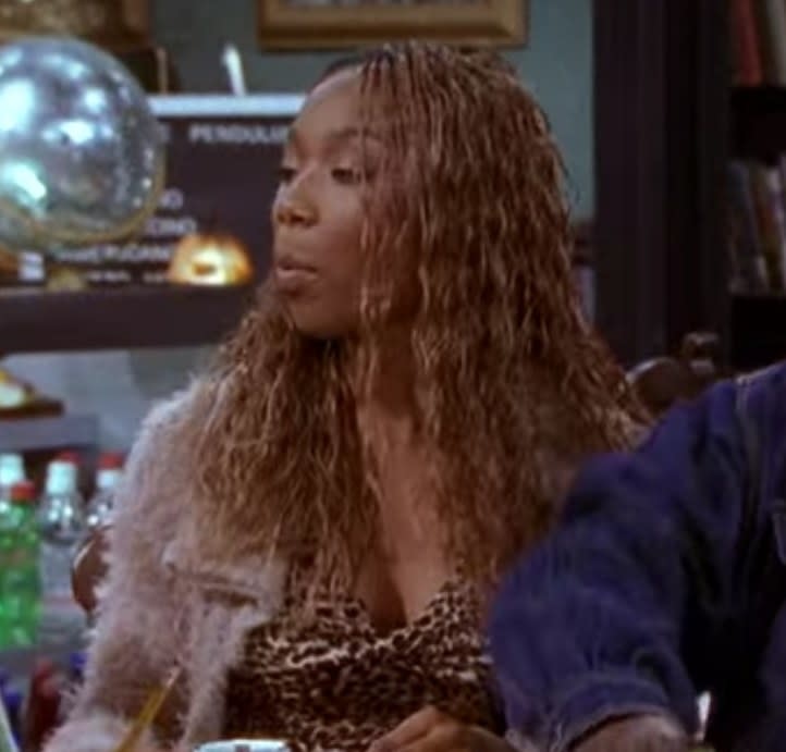 Moesha wearing cheetah print dress with shaggy fur coat