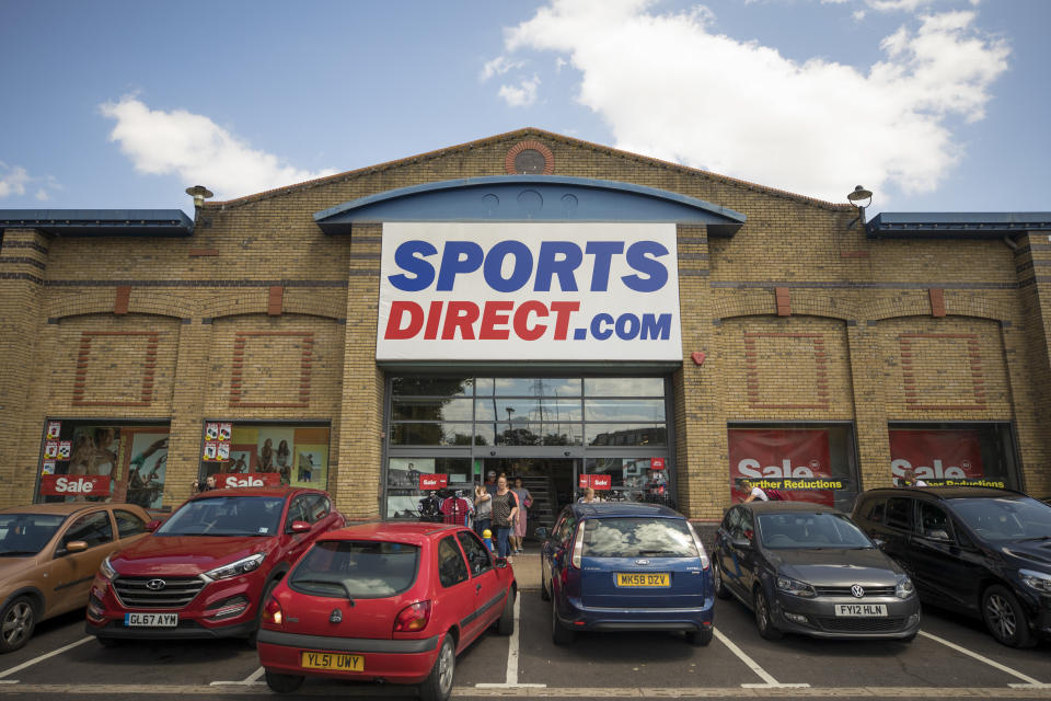 An automobile reverses from a parking space outside a Sports Direct International Plc store. Photo: Jason Alden/Bloomberg