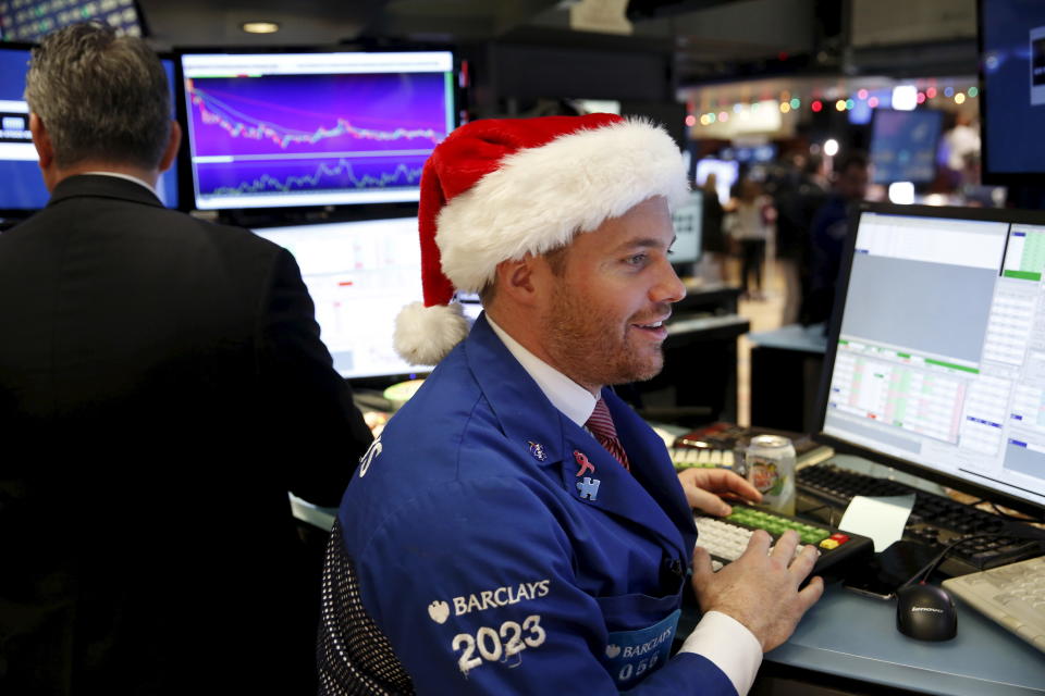 A trader wears a Santa hat as he works on the floor of the New York Stock Exchange the day before Christmas in New York December 24, 2015. REUTERS/Lucas Jackson