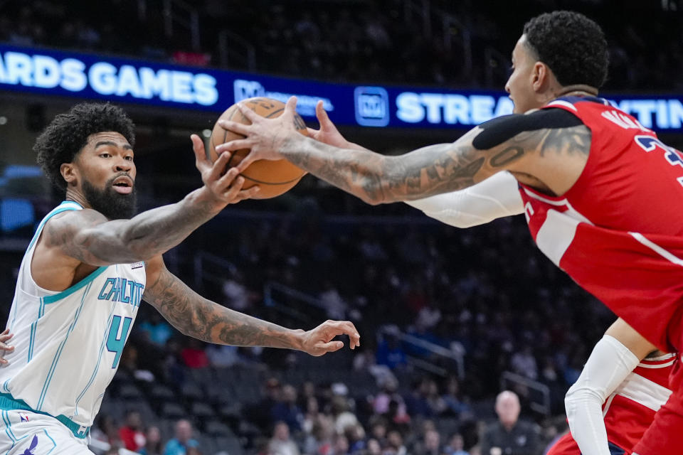 Charlotte Hornets center Nick Richards (4) can't grab a rebound from Washington Wizards forward Kyle Kuzma (33) during the first half of an NBA basketball game Friday, March 8, 2024, in Washington. (AP Photo/Alex Brandon)