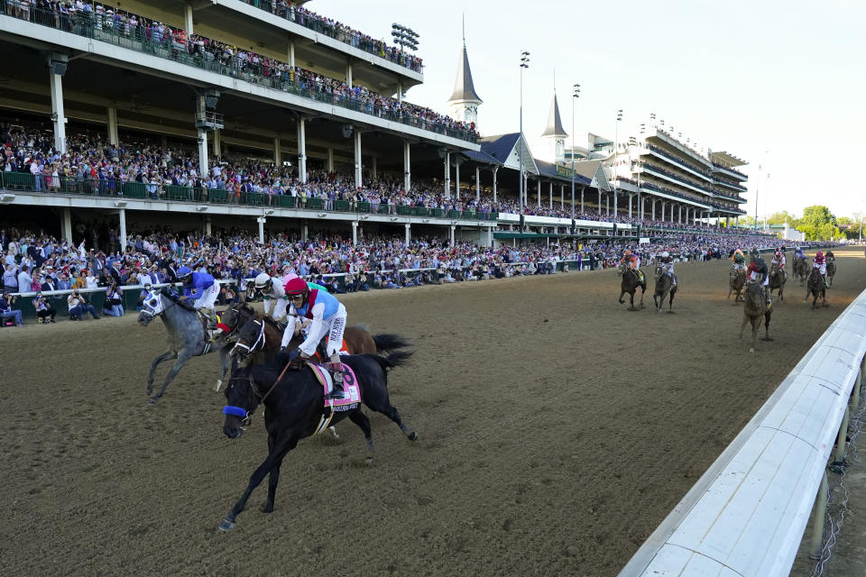 John Velazquez riding Medina Spirit leads Florent Geroux on Mandaloun, Flavien Prat riding Hot Rod Charlie and Luis Saez on Essential Quality to win the 147th running of the Kentucky Derby at Churchill Downs, Saturday, May 1, 2021, in Louisville, Ky. (AP Photo/Jeff Roberson)